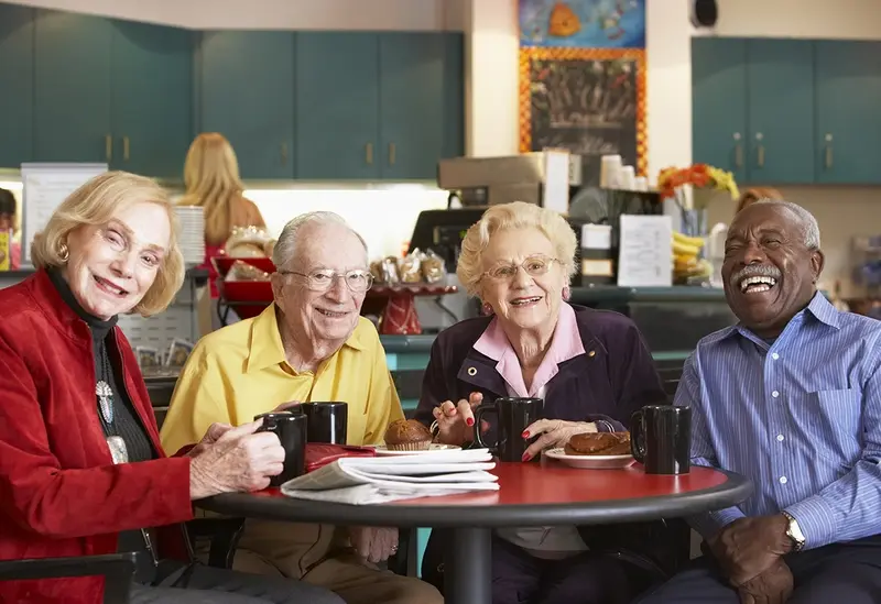 A group of four people enjoy each other's company at a table